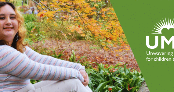 Woman posing in front of tree