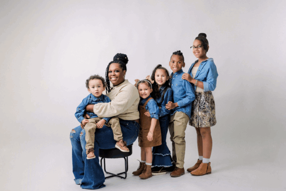 A woman posing with 5 kids