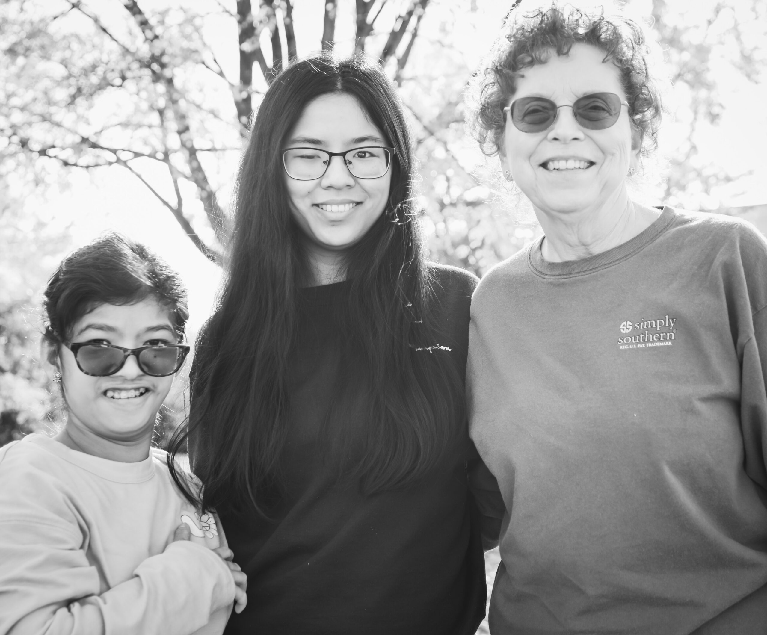 Woman standing with 2 kids outside