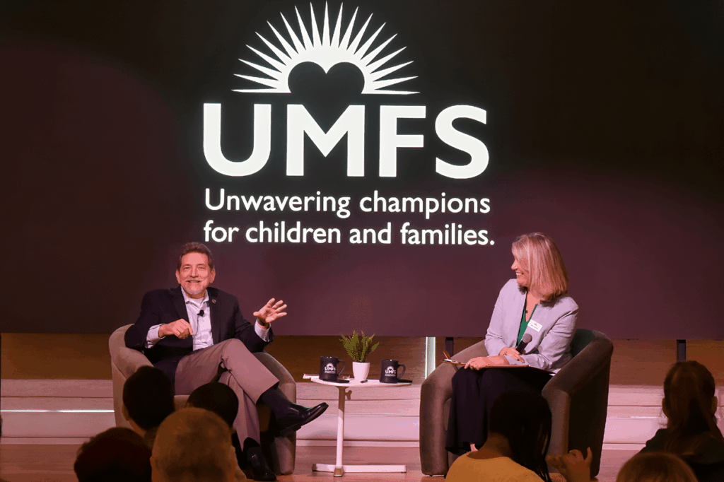 Two people speaking at a conference
